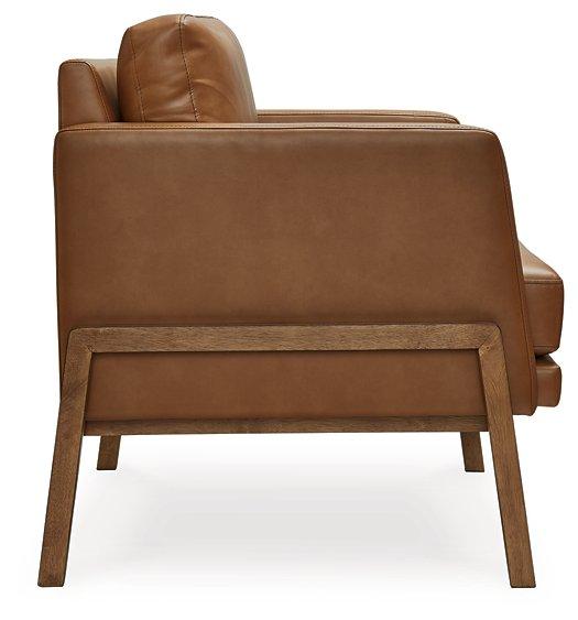 Ashley Furniture Numund accent chair with a modern design, featuring plush fabric upholstery and wooden legs.