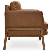 Ashley Furniture Numund accent chair with a modern design, featuring plush fabric upholstery and wooden legs.