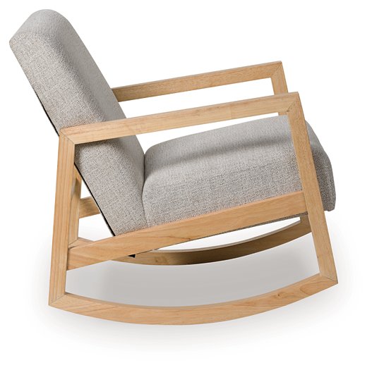 Ashley Furniture Wychworth accent chair with plush fabric and wooden legs, shown from a side view.