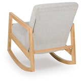Ashley Furniture Wychworth accent chair with dark wooden legs and plush beige upholstery, shown from the back.
