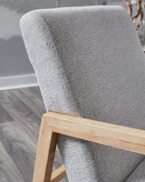 Ashley Furniture Wychworth Accent Chair with plush fabric and wooden legs, shown in a cozy living room setting.