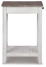 Ashley Furniture Adalane accent table with a sleek wooden top and metal legs, perfect for living room decor.