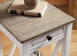 Ashley Furniture Adalane accent table with a round wooden top and black metal legs, ideal for living room or bedroom decor.