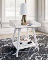 Ashley Furniture Blariden accent table with a sleek wooden surface and modern design, ideal for living room or bedroom decor.