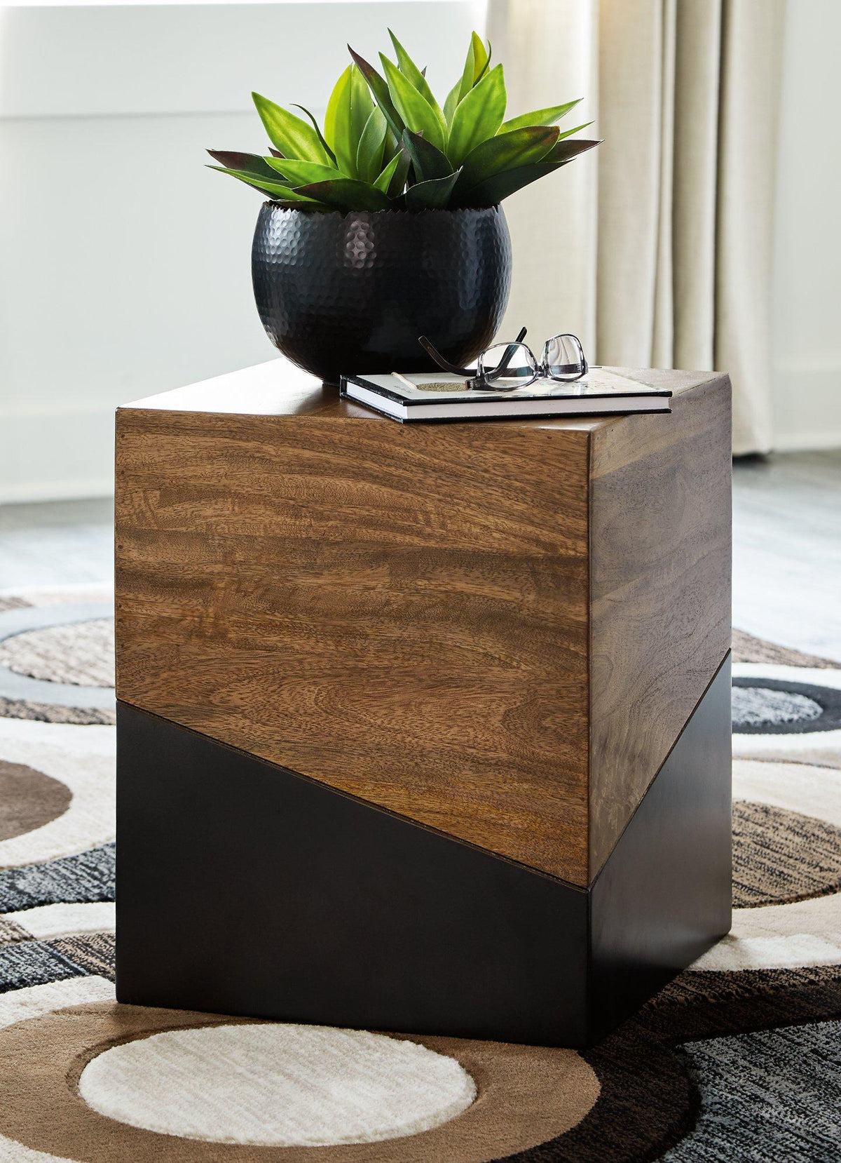 Ashley Furniture Trailbend Accent Table with a smooth wooden surface and curved design, perfect for living room decor.