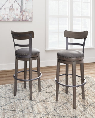 Ashley Furniture Caitbrook bar height bar stool with wooden legs and upholstered seat, shown from a side angle.