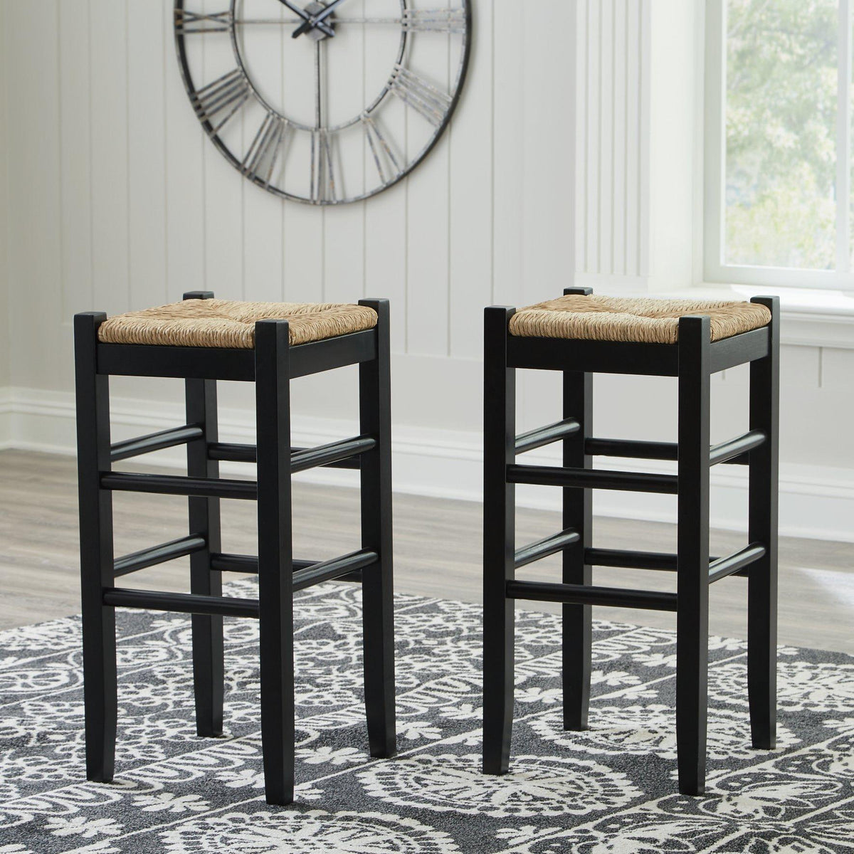 Ashley Furniture Mirimyn bar height bar stool with wooden legs and upholstered seat, shown from a side angle.
