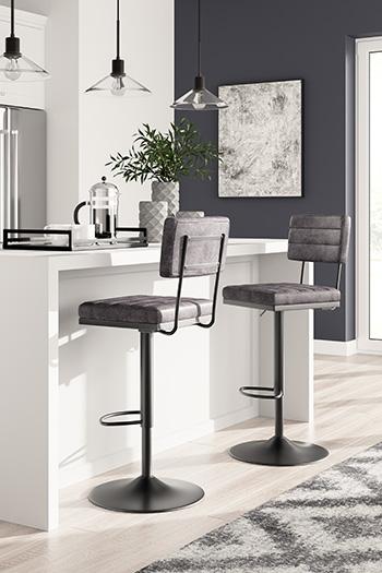 Ashley Furniture Strumford bar height barstool with wooden legs and upholstered seat, shown in a modern interior setting.
