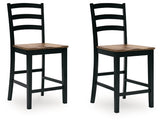 Ashley Furniture Wildenauer counter height barstool with wooden legs and a cushioned seat, shown from an angled side view.