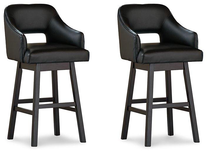 Set of Ashley Furniture Tallenger barstools with wooden seats and metal legs, arranged around a modern kitchen island.