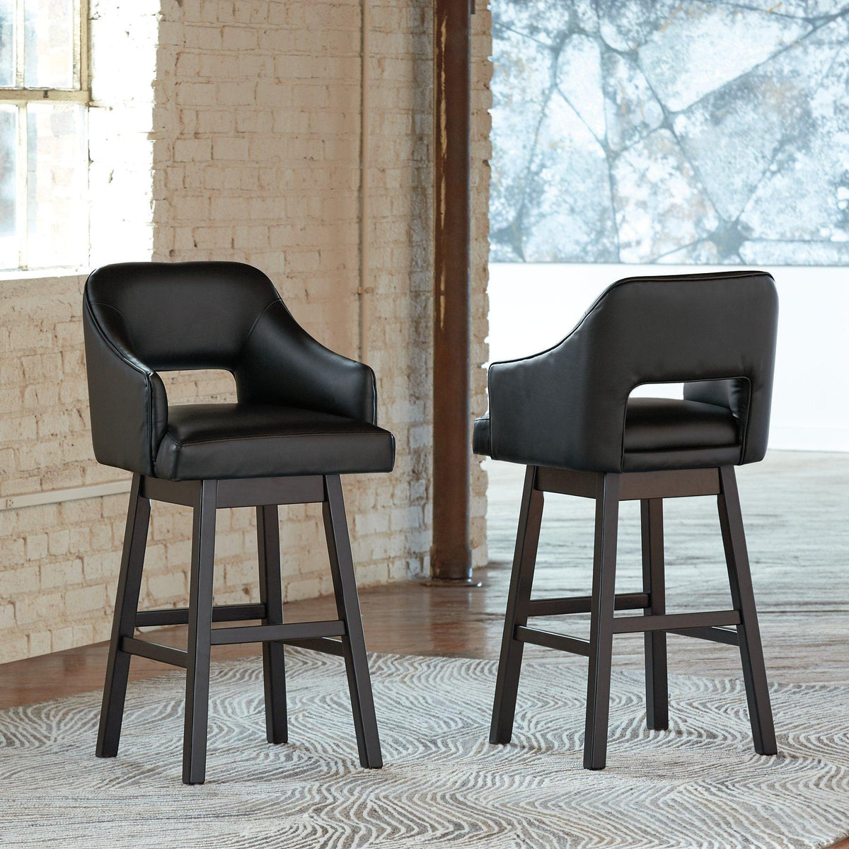 Set of Ashley Furniture Tallenger barstools with wooden seats and metal legs, ideal for kitchen or bar area seating.