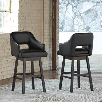 Set of two Ashley Furniture Tallenger barstools with wooden legs and upholstered seats, ideal for kitchen or bar counter seating.