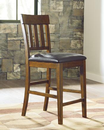Set of Ashley Furniture Ralene Bar Stools with wooden seats and metal legs, arranged around a modern kitchen island.