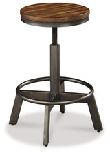 Set of four Ashley Furniture Torjin barstools with wooden legs and upholstered seats, perfect for kitchen or bar area.