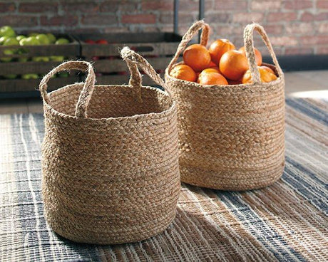 Set of two Brayton baskets from Ashley Furniture, woven storage baskets with handles and natural finish.