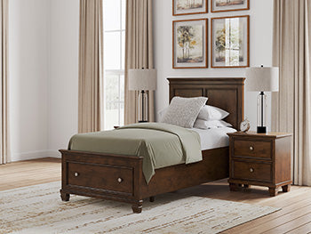 Ashley Furniture Danabrin panel storage bed with sleek wood finish and built-in storage drawers in a modern bedroom setting.
