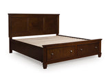 Ashley Furniture Danabrin panel storage bed with a dark wood finish, showcasing a sleek, closed storage design from an angled view.