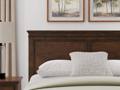 Ashley Furniture Danabrin panel storage bed with sleek wood finish and built-in storage drawers in a modern bedroom setting.