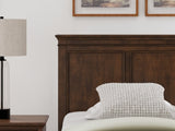 Ashley Furniture Danabrin panel storage bed with a dark wood finish and built-in storage drawers in a modern bedroom setting.