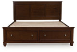 Ashley Furniture Danabrin Panel Storage Bed with a headboard, showcasing a modern wood finish and built-in storage drawers.