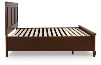 Ashley Furniture Danabrin Panel Storage Bed with sleek wood finish and built-in storage drawers in a modern bedroom setting.