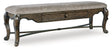 Maylee 63-inch dining bench by Ashley Furniture, wooden seat with tapered legs, ideal for kitchen or dining room seating