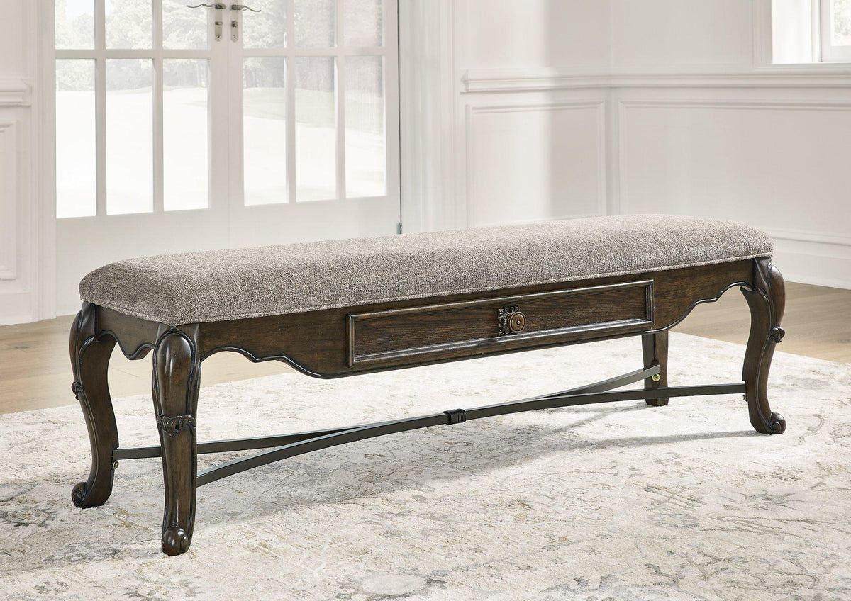 Maylee 63-inch wooden dining bench by Ashley Furniture with a sleek, modern design, perfect for kitchen or dining room seating.