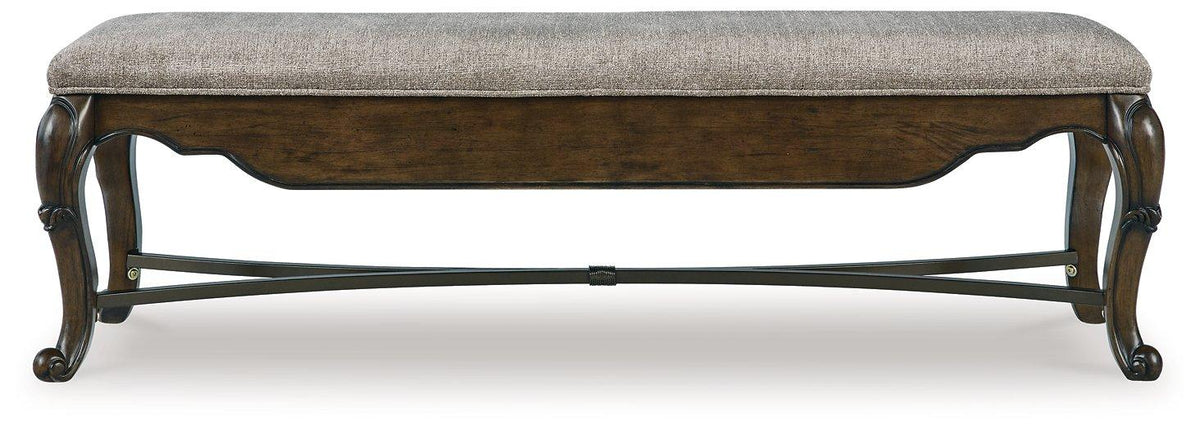Ashley Furniture Maylee 63-inch wooden dining bench with cushioned seat and sturdy legs, ideal for kitchen or dining room.