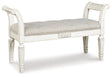 Ashley Furniture Realyn Accent Bench with cushioned seat and wooden legs, ideal for entryways or living rooms.