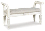 Ashley Furniture Realyn Accent Bench with cushioned seat and wooden legs, ideal for entryways or living rooms.