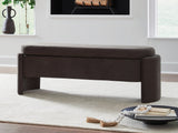 Ashley Furniture Vavuniya storage bench with cushioned top and wooden legs, ideal for entryway or living room storage.