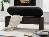 Open Vavuniya storage bench by Ashley Furniture with a wooden top and fabric storage compartment for living room organization.