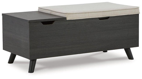Ashley Furniture Yarlow Storage Bench with cushioned top and wooden legs, ideal for entryway or living room storage and seating.