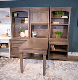 Ashley Furniture Janismore Bookcase with open shelves and storage compartments in a modern wood finish.