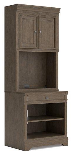 Ashley Furniture Janismore bookcase with multiple shelves, showcasing a stylish wooden storage unit for home or office use.