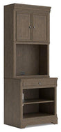 Ashley Furniture Janismore bookcase with multiple shelves, showcasing a stylish wooden storage unit for home or office use.