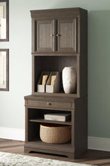 Ashley Furniture Janismore Bookcase with multiple shelves and wood finish, ideal for home or office storage.