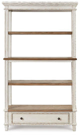 Ashley Furniture Realyn 75-inch bookcase with open shelves and a warm wood finish, ideal for living room or office storage.