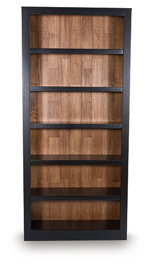 Wildenauer 75-inch wooden bookcase by Ashley Furniture showing tall, spacious shelves and classic design in a natural wood finish.