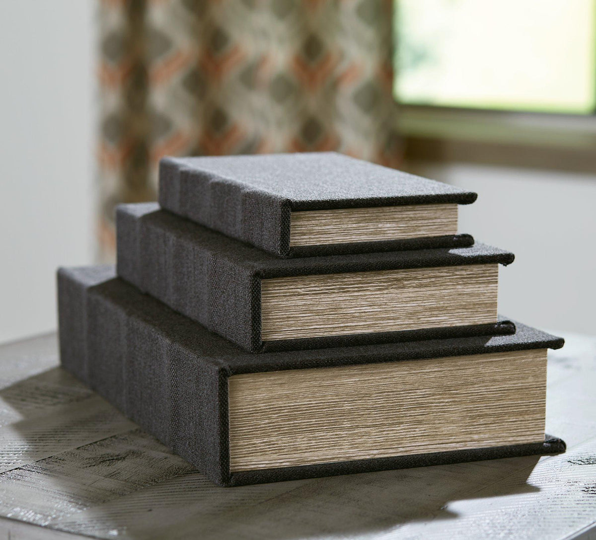 Set of three Jolina storage boxes from Ashley Furniture shown in a natural wood finish with sleek, functional design.