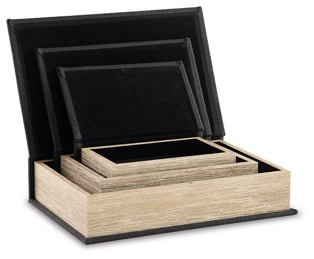 Set of three Jolina storage boxes from Ashley Furniture, featuring woven and fabric textures with lid closures.