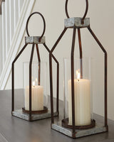 Two Diedrick Lantern candle holders by Ashley Furniture with metal frames and glass panels, suitable for decorative lighting.