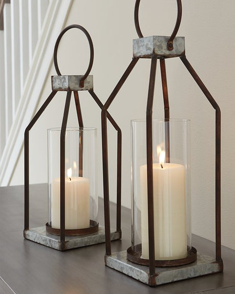 Two Diedrick Lantern candle holders by Ashley Furniture with metal frames and glass panels, suitable for decorative lighting.