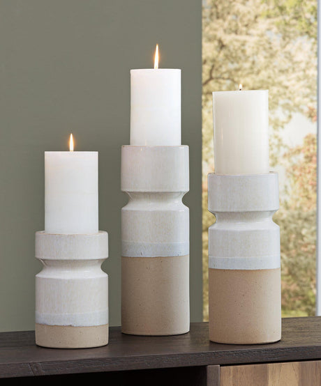 Set of three Ashley Furniture Hurston Candle Holders with rustic metal finish and varied heights for decorative tabletop display.