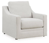 Ashley Furniture Adda Chair with plush fabric upholstery, angled design, and wooden legs in a stylish and modern living room setting.