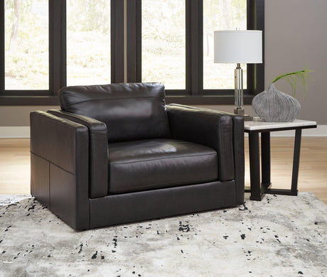 A large Ashley Furniture Amiata Oversized Chair with plush fabric and wide armrests, ideal for comfortable seating in modern living rooms.