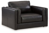 A large, plush Amiata Oversized Chair by Ashley Furniture with soft fabric upholstery and wide armrests.