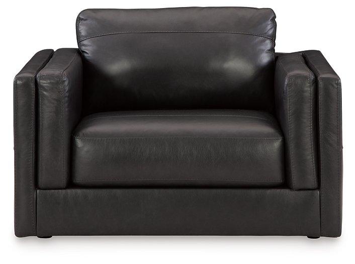 A large Ashley Furniture Amiata oversized leather chair with plush cushioning and sleek design in a modern living space.