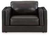 A large Ashley Furniture Amiata oversized leather chair with plush cushioning and sleek design in a modern living space.