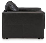 A large Amiata oversized chair by Ashley Furniture with plush fabric and wide armrests, ideal for a cozy living room seating area.